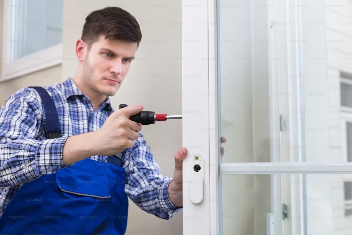 Two installers replacing a window on a suburban home